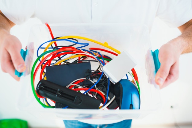 young-man-isolated-white-wall-cut-view-man-s-hands-holding-plastic-box-with-cords-batteries-recycling-process-no-waste-lifestyle_186523-1362